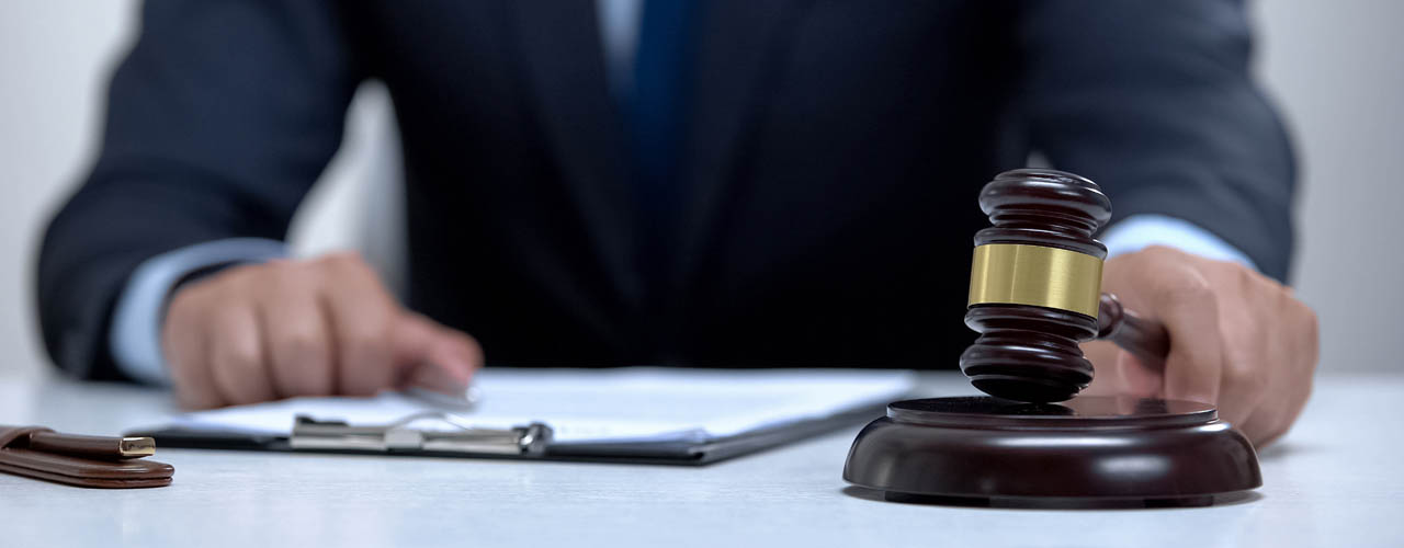 Male judge banging gavel on block, court determines sentence, pr