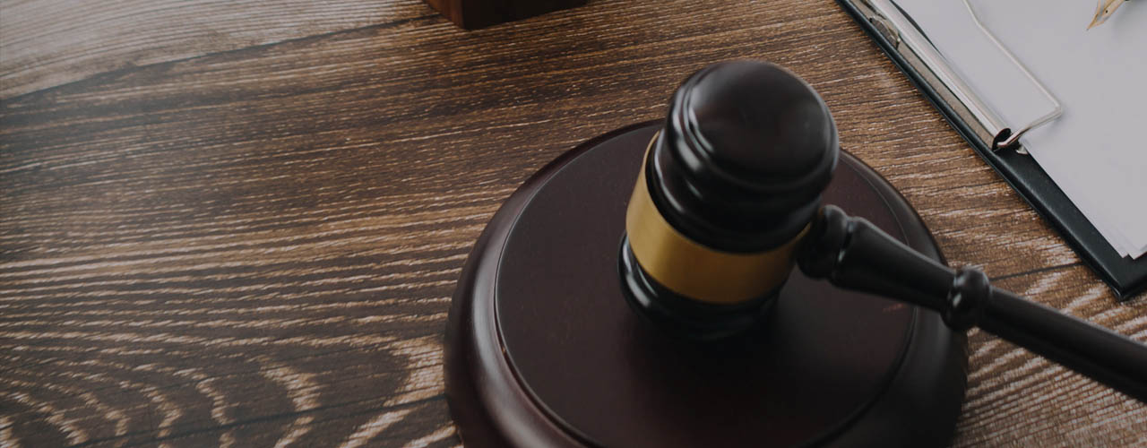 Business and lawyers discussing contract papers with brass scale