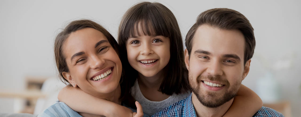 Family Picture Of Funny Preschooler Hug Smiling Parents